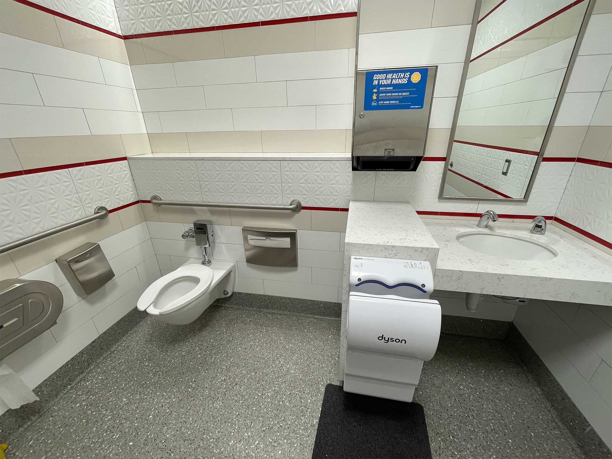 Accessible family bathroom with toilet and sink at Boston airport.