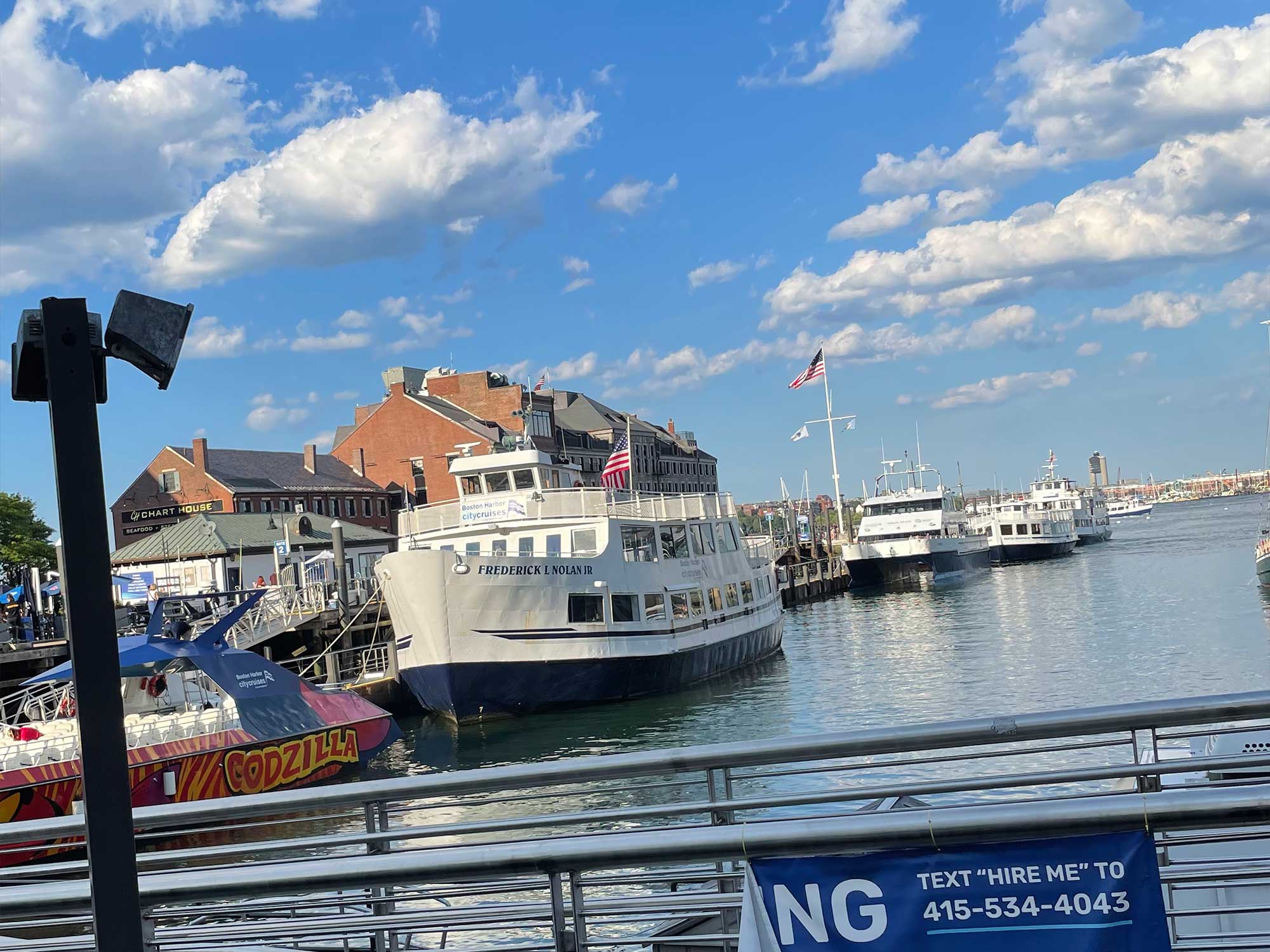 Sightseeing cruise ship docked at wharf.