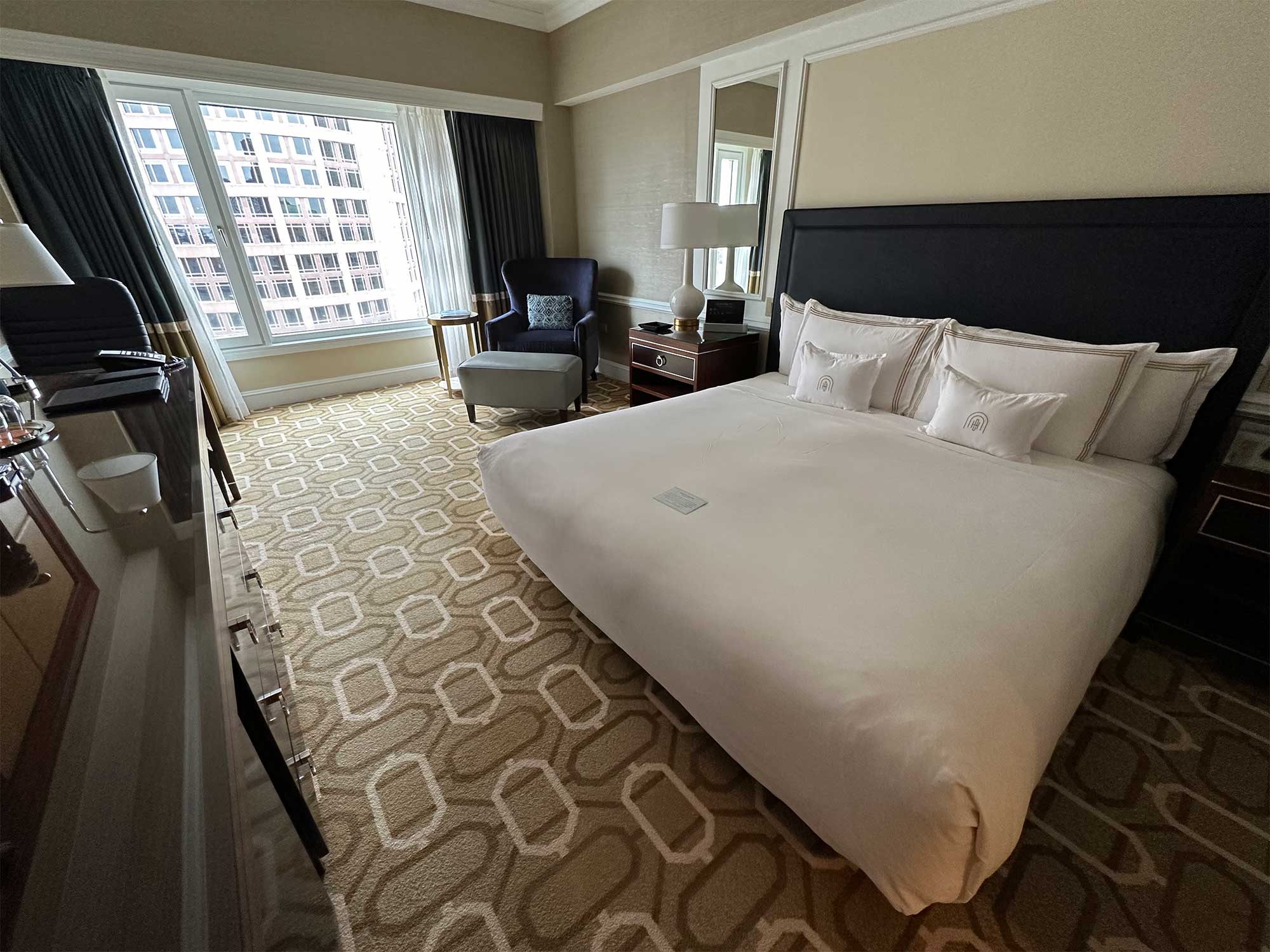 King size bed in hotel room.