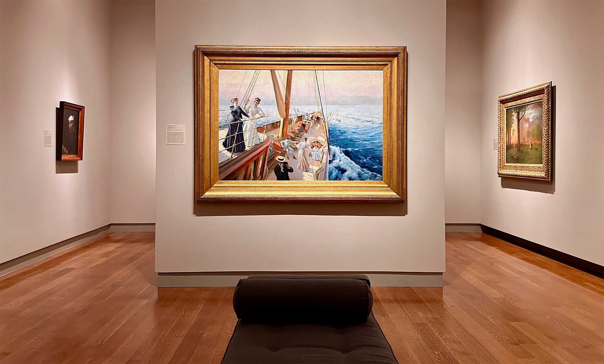 Painting of people on a sailboat placed in a prime location in a museum.