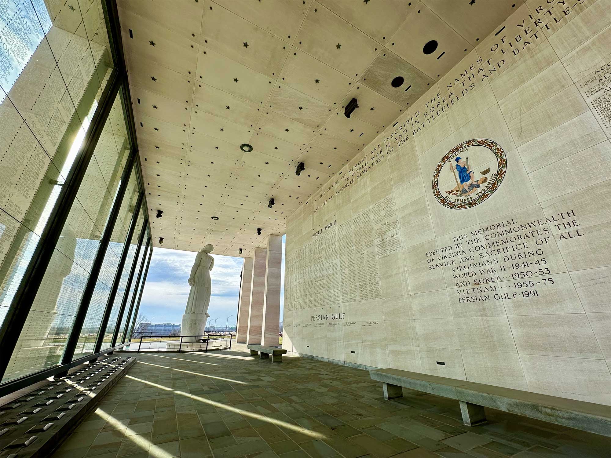 War memorial with names of soldiers carved into wall and written on glass.