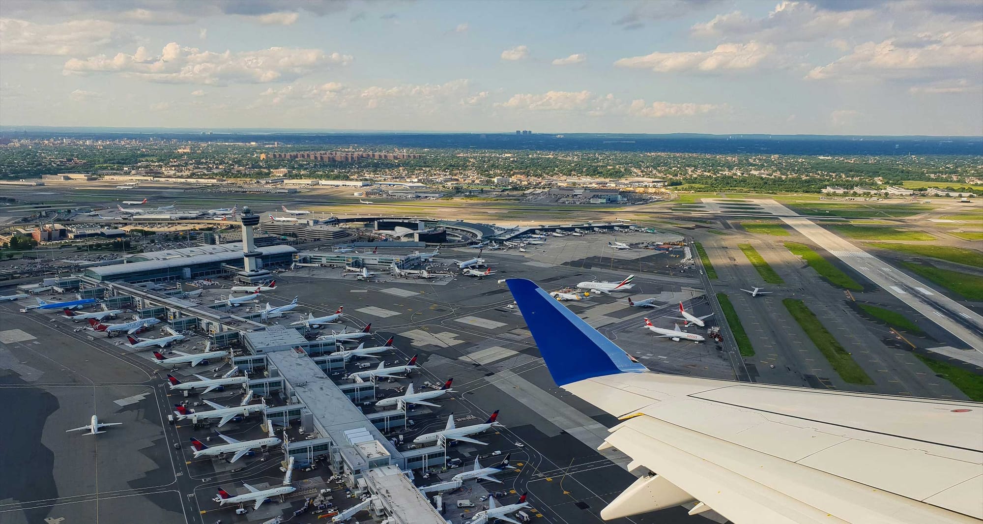 JFK Airport terminal building seen from the window of a departing flight.