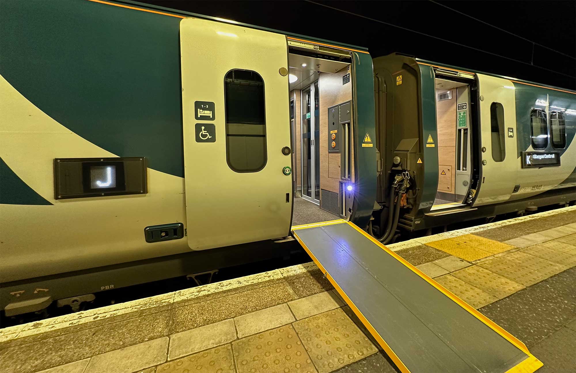 Elongated wheelchair ramp from station platform to train door.