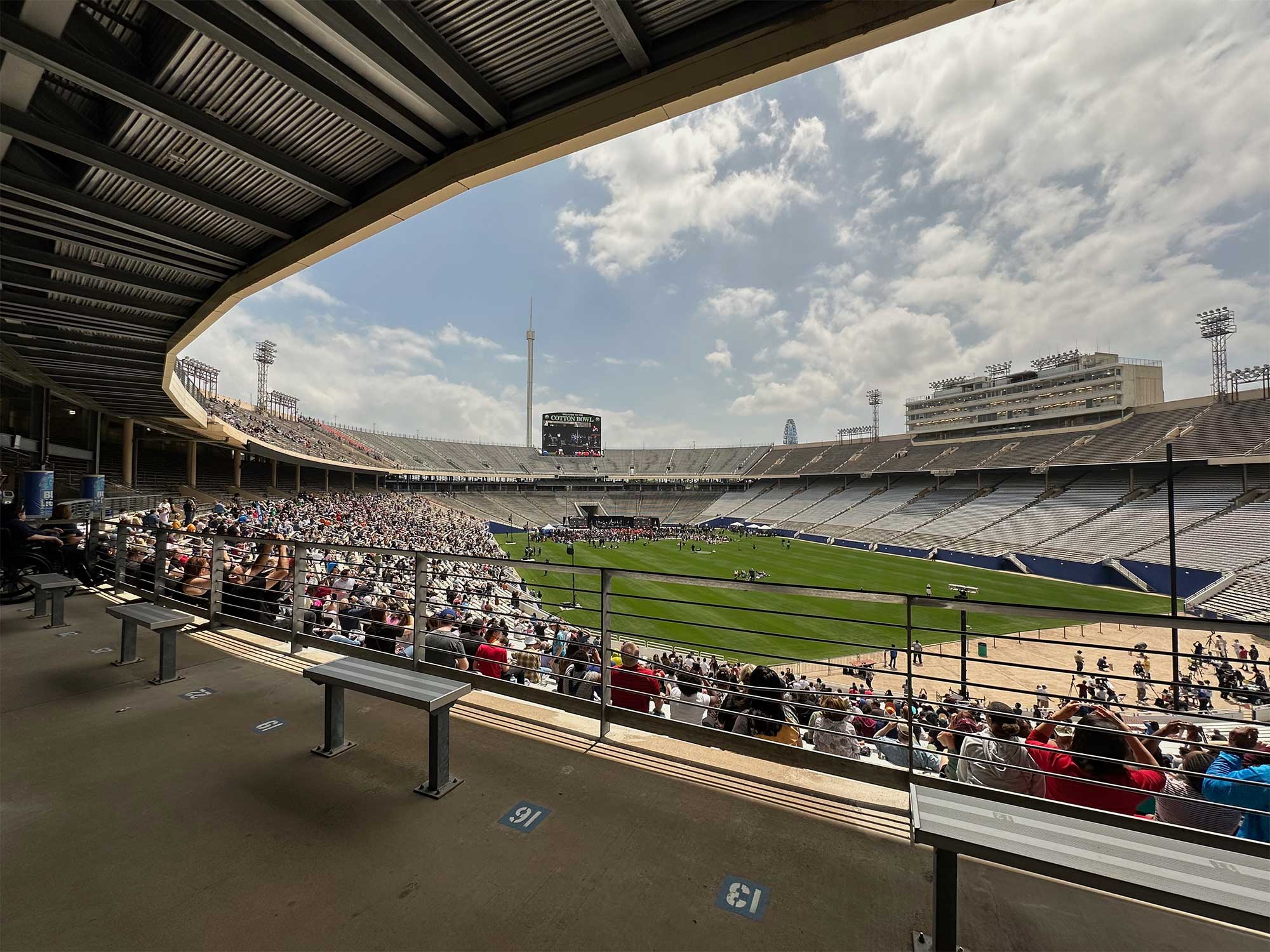 Wheelchair seating spaces in stadium with overhang that blocks view of sky.