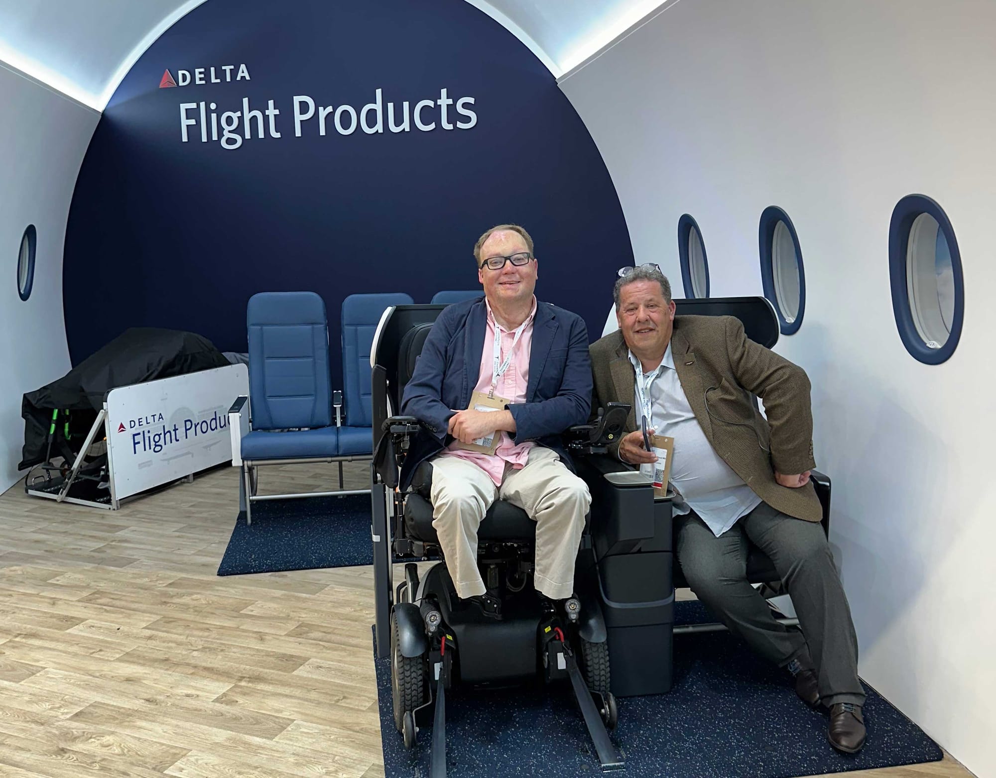 John seated in his wheelchair secured to the prototype seat. Chris Wood sits in the adjacent companion seat in the mock up.