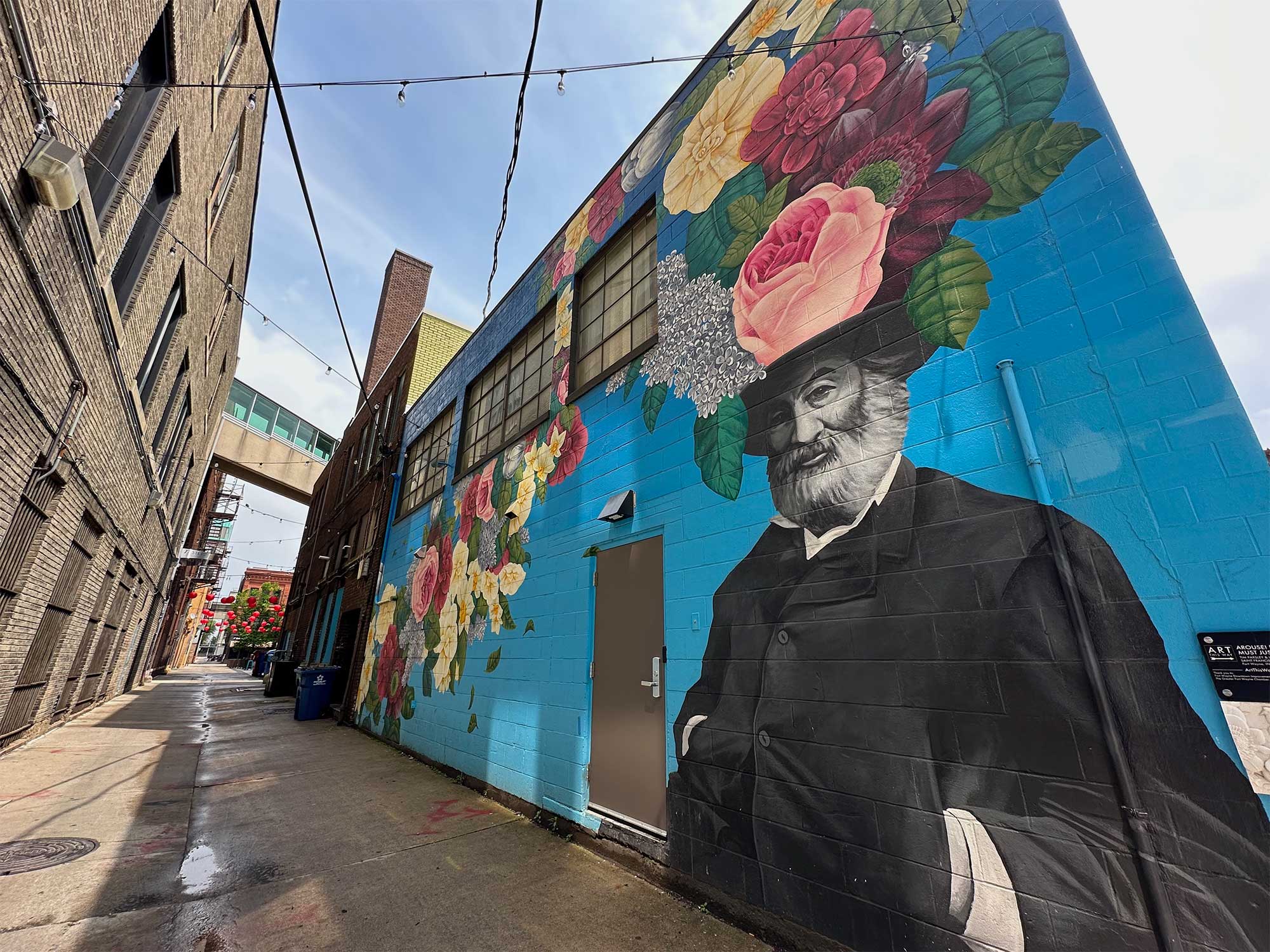 Artwork, Walt Whitman portrait surrounded by flowers.