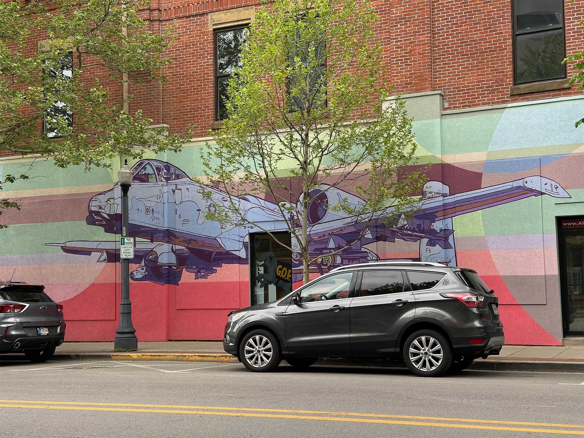 Artwork, fighter jet ,mural on side of building.