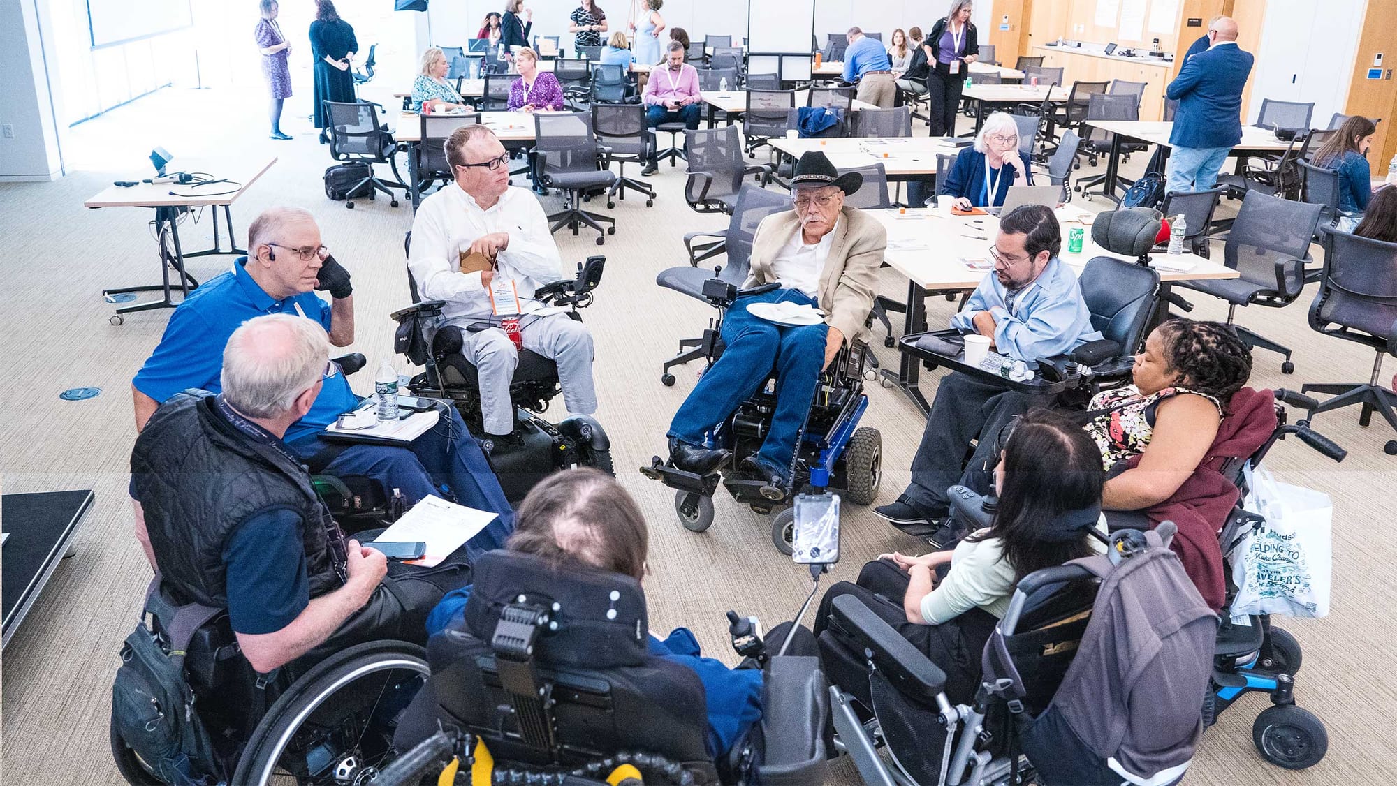 Wheelchair users gathered in a circle.